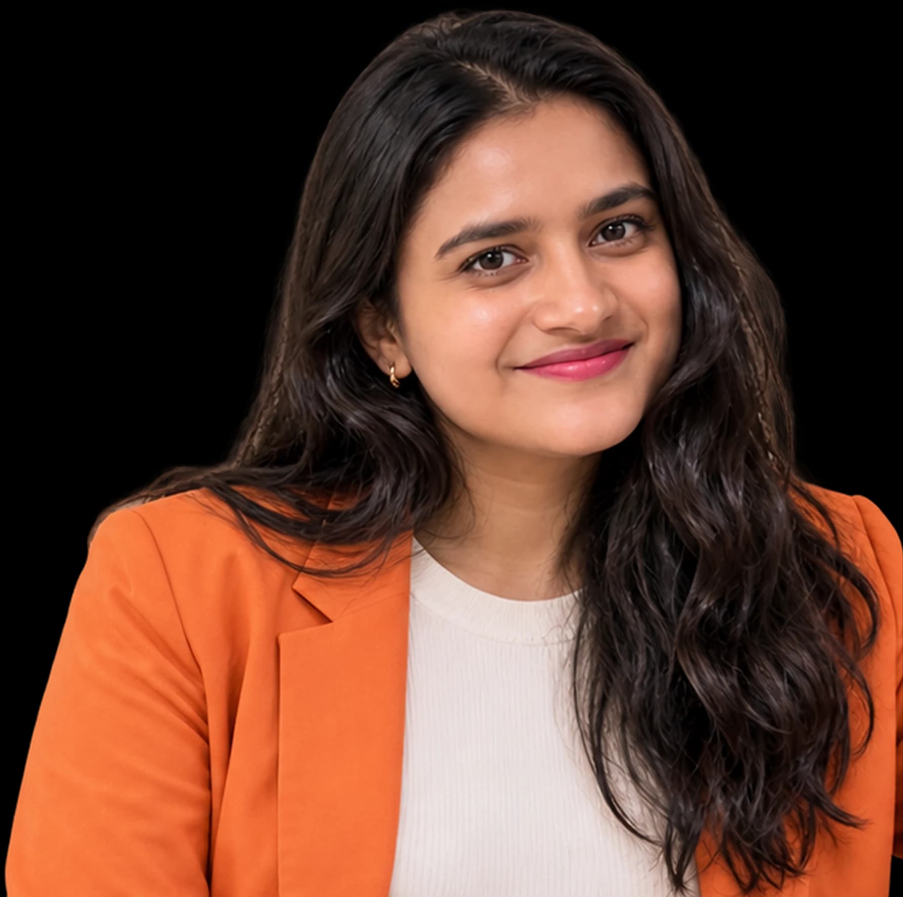Vibha, founder of Pecan, in an orange blazer